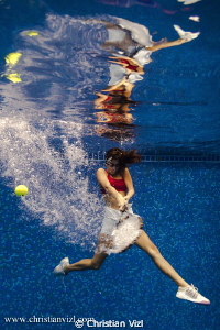 Woman playing tennis underwater, just for the fun of it! by Christian Vizl 